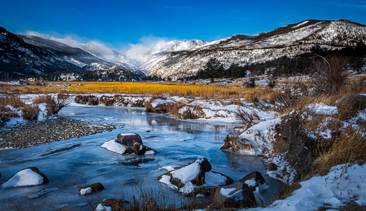 Stream ith Snow and Mountain Background