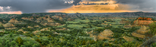 colorful eroded hills partially covered with vegetation