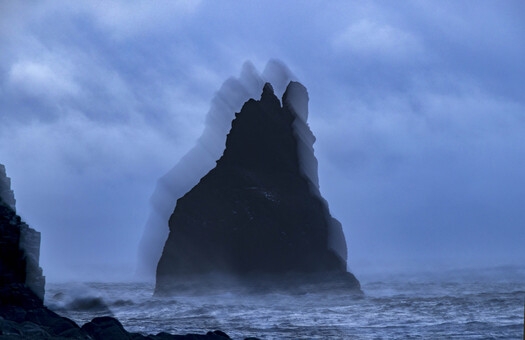 Steep rock jutting out of the ocean