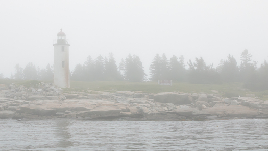 Lighthouse on a foggy island