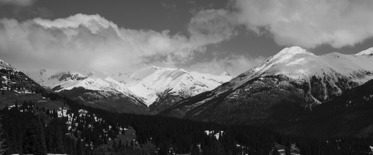 Clouds over snow0cappped mountains