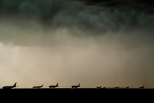 Airplans lined up under a cloudy sky
