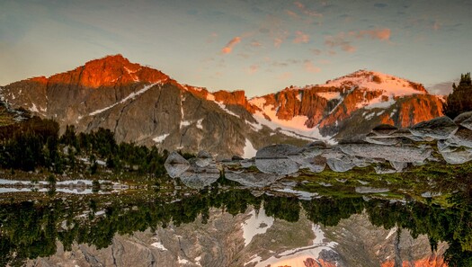 mountains and snowfields reflected in water