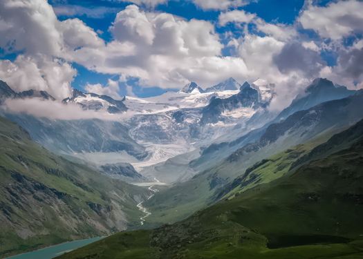 Mountains surrounding a deep valley with a river flowing through it
